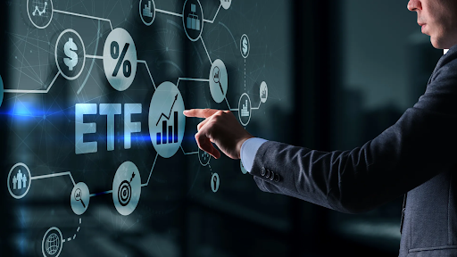 – PU Prime | More Than Trading man looking at screen that has the word “ETF” and related icons