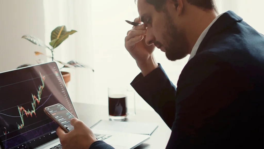 trader-feeling-frustrated-after-looking-at-trading-chart-trends-on-app-and-desktop