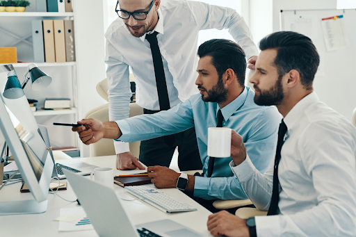 three-businessmen-developing-new-trading-strategies-in-front-of-monitors – PU Prime | More Than Trading three businessmen developing new trading strategies in front of monitors